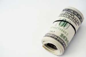 rolled bundle of dollars